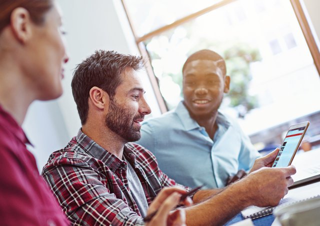 young-man-laughing-working-with-others